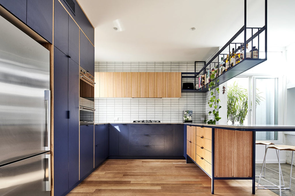 White tile, concrete, and steel accents connect a contemporary home with the industrial heritage of its site.